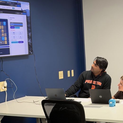 Students watching an AI model train on the classroom screen