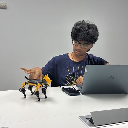 A teen programming a robot dog