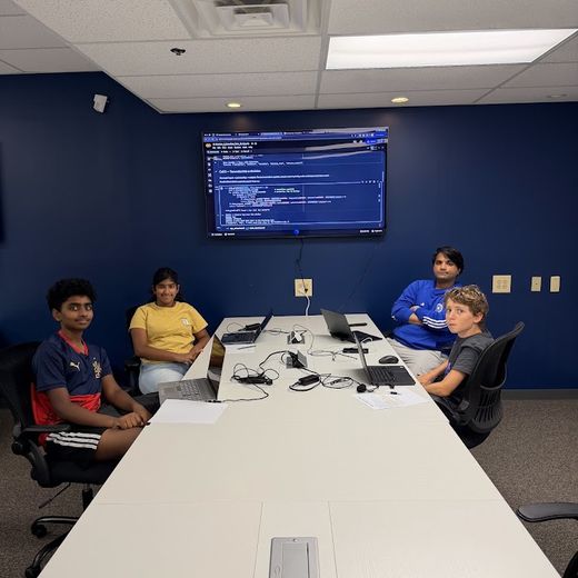 A small group coding around the classroom table